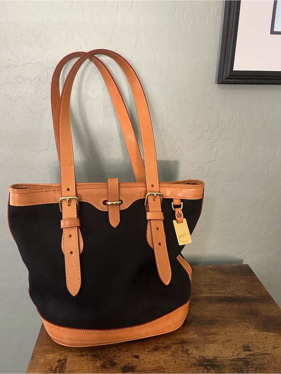 Dooney & Bourke Handbags - Dooney & Bourke cabriolet black canvas bag with Tan Leather Trim and Gold